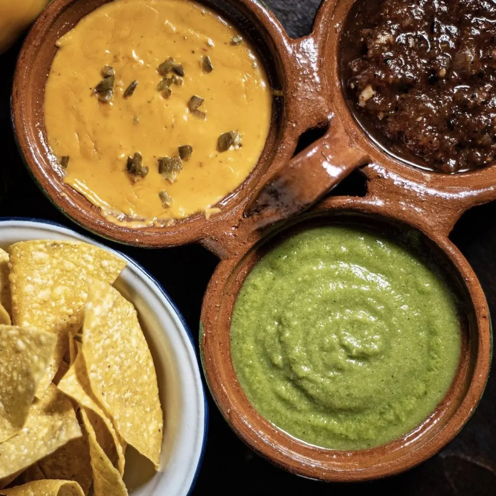 Trio Dip and Chips: jalapeño queso, molcajete and creamy green salsa with homemade tortilla chips