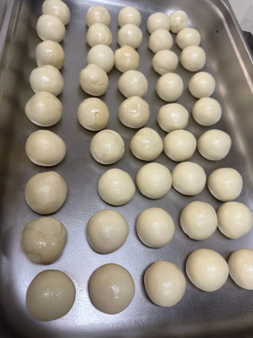 Tray of hand-rolled flour tortilla dough balls